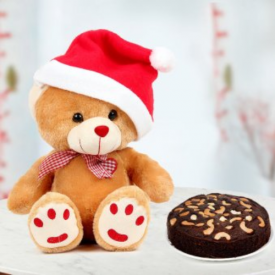 Christmas teddy bear with a red cap and chocolate cake.