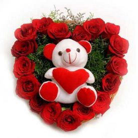 A heart shaped 50 red roses with cute teddy bear