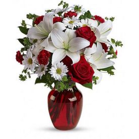 luxurious flowers in classic winter colors. Red roses, snow white lilies and with graceful red gl
