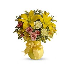 yellow assortment of lilies, roses, alstroemeria and assorted greens are presented in a lovely yello