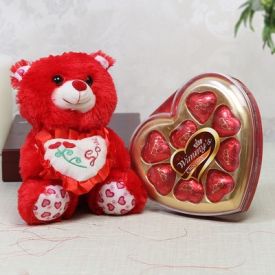 Adorable teddy with heart shape chocolate