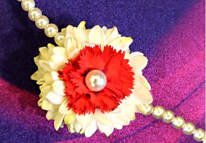 Pretty rakhi with fresh red carnation